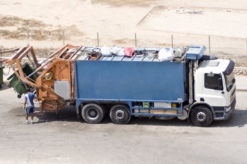 Workers loading office rubbish into van near high street shop